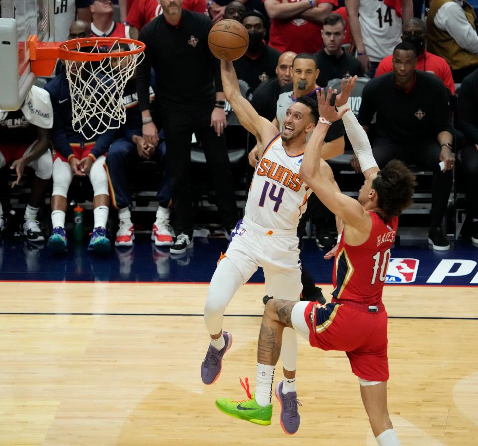 Apr 22, 2022; New Orleans, Louisiana, U.S.;  Phoenix Suns guard Landry Shamet (14) goes for a dunk against New Orleans Pelicans center Jaxson Hayes (10) during Game 3 of the Western Conference playoffs. Mandatory Credit: Michael Chow-Arizona Republic