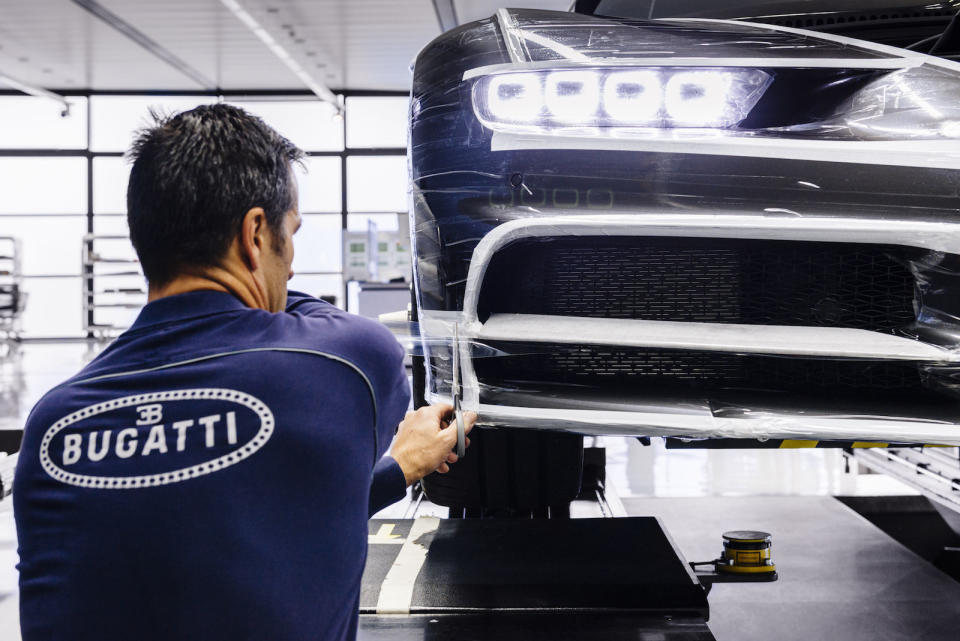 <p>Each car is wrapped in a layer of plastic for its final test drive.</p>