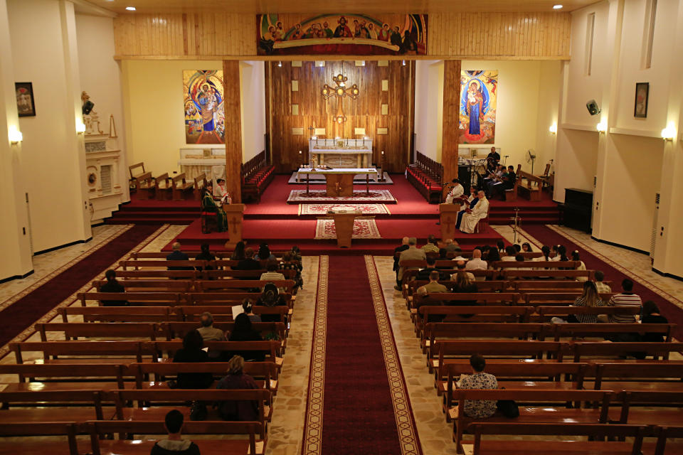 In this Sunday, Nov. 4, 2018, photo with attendance low because of ongoing security concerns, Iraqi Christians pray during Sunday Mass in the near empty Mar Youssif Chaldean Church in Baghdad. (AP Photo/Karim Kadim)