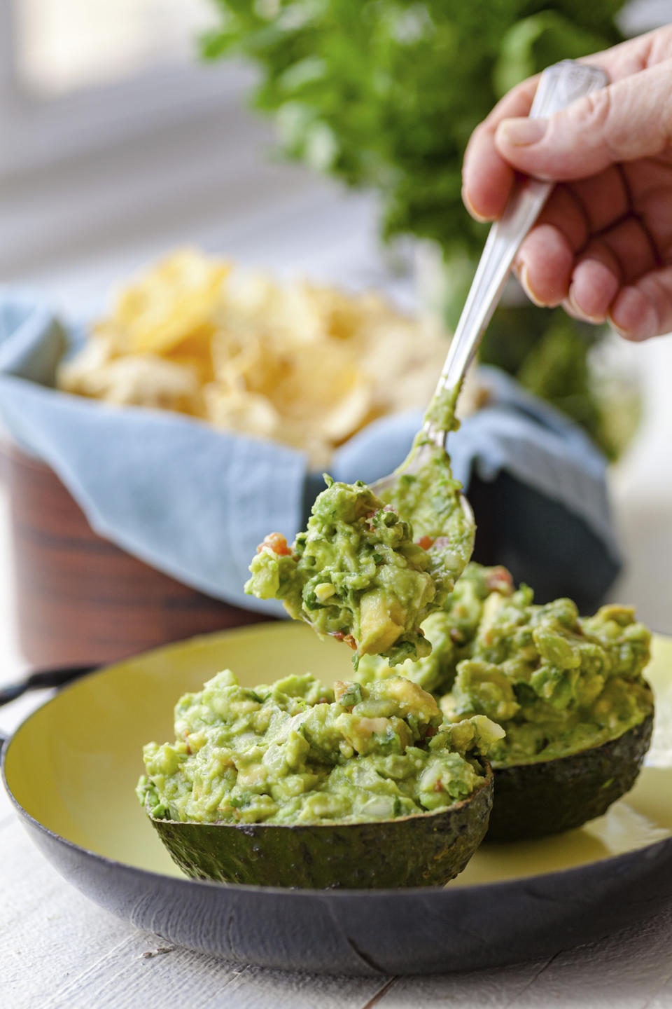 A recipe for guacamole, served in an avocado shell, appears in New York in June 2019. (Carrie Crow via AP)