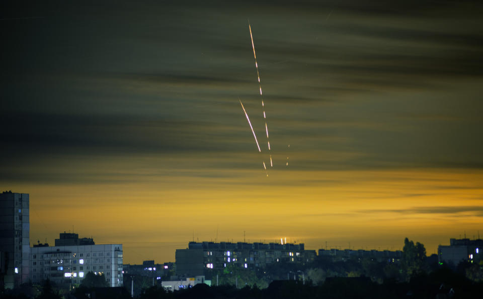 Russian rockets launched against Ukraine from Russia's Belgorod region are seen at dawn in Kharkiv, Ukraine, Wednesday, Sept. 21, 2022. (AP Photo/Vadim Belikov)