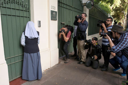 A nun wait to enter at the apostolic nunciature where the Vatican special envoy Archbishop Charles Scicluna meets with victims of sexual abuses allegedly committed by members of the church in Santiago, Chile. February 20, 2018. REUTERS/Claudio Santana