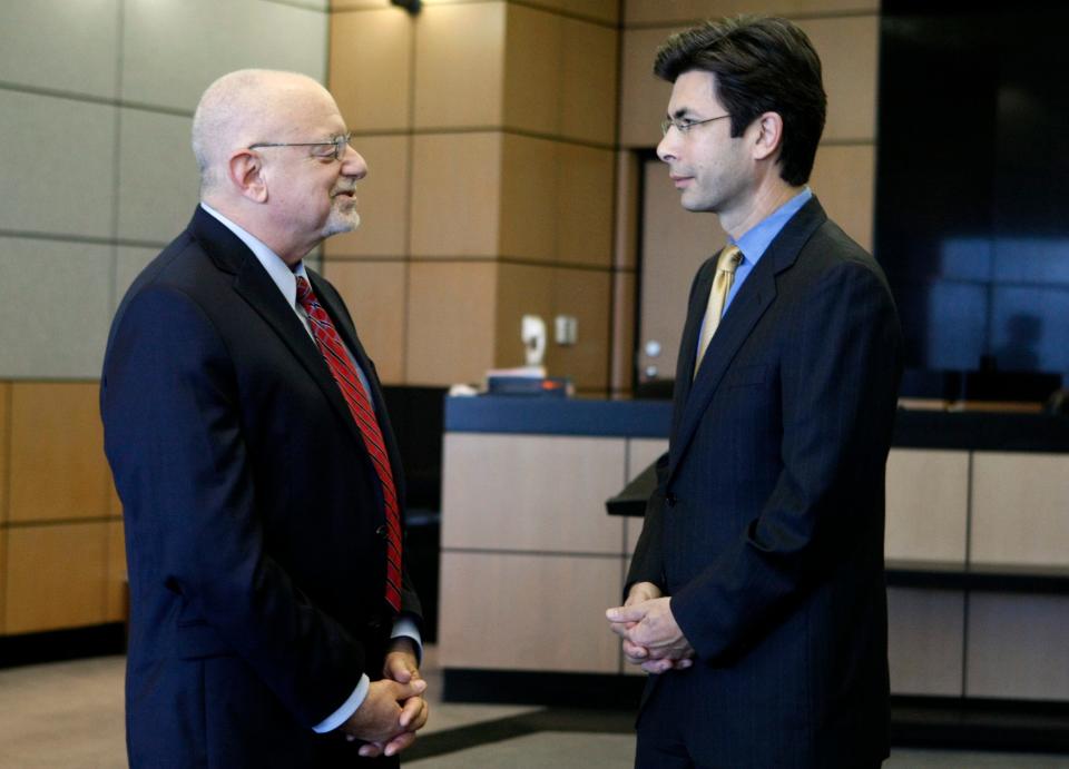 Pete Antonacci, left, being sworn in as Palm Beach County's interim state attorney in 2012. Antonacci took over for former State Attorney Michael McAuliffe, right.