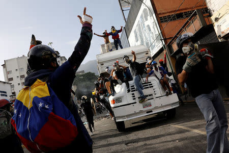 Demonstrators stand on a truck while clashing with riot security forces during a rally against Venezuela's President Nicolas Maduro in Caracas, Venezuela, May 31, 2017. REUTERS/Carlos Garcia Rawlins