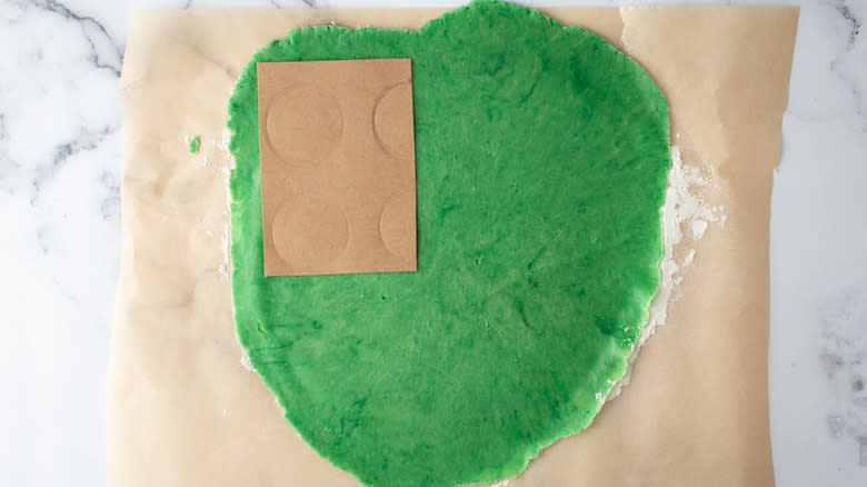 cardboard rectangle on green dough