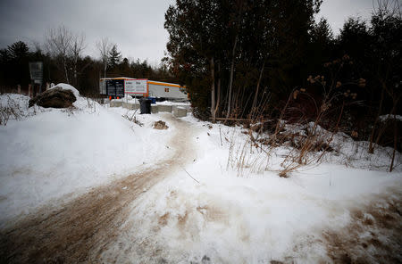 A path in the snow leads to the Canadian side of US-Canada border as seen from Champlain, New York, U.S., February 14, 2018. Picture taken February 14, 2018. REUTERS/Chris Wattie