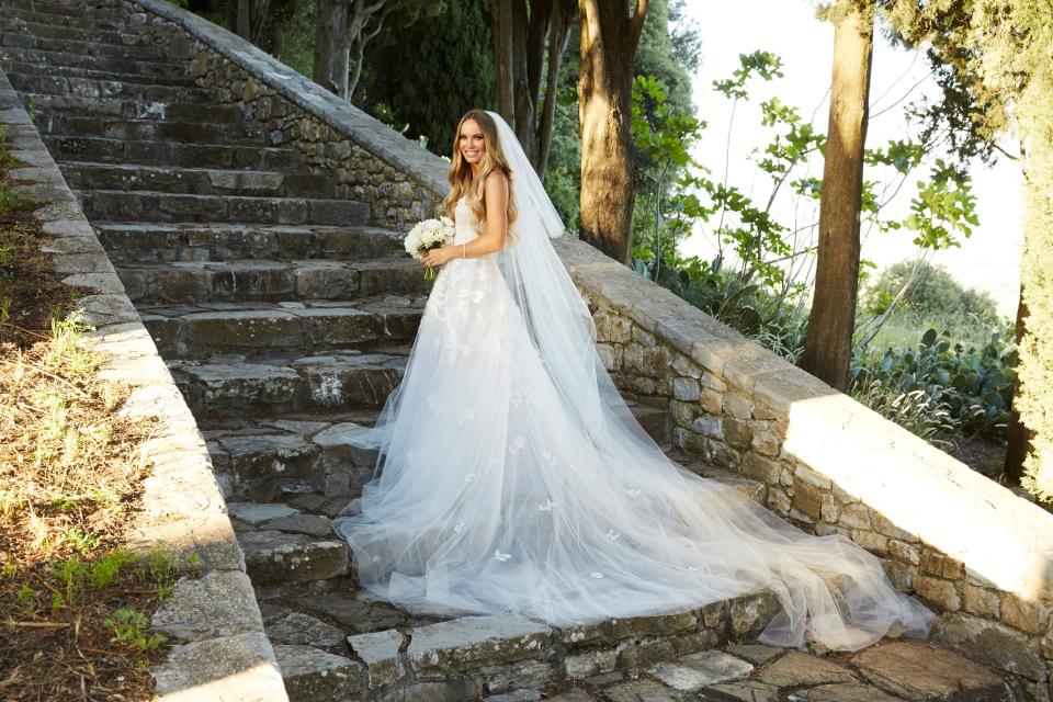 Caroline on the steps leading up to the castle ruins in her custom ordered Oscar de la Renta fern and floral lace embroidered gown.