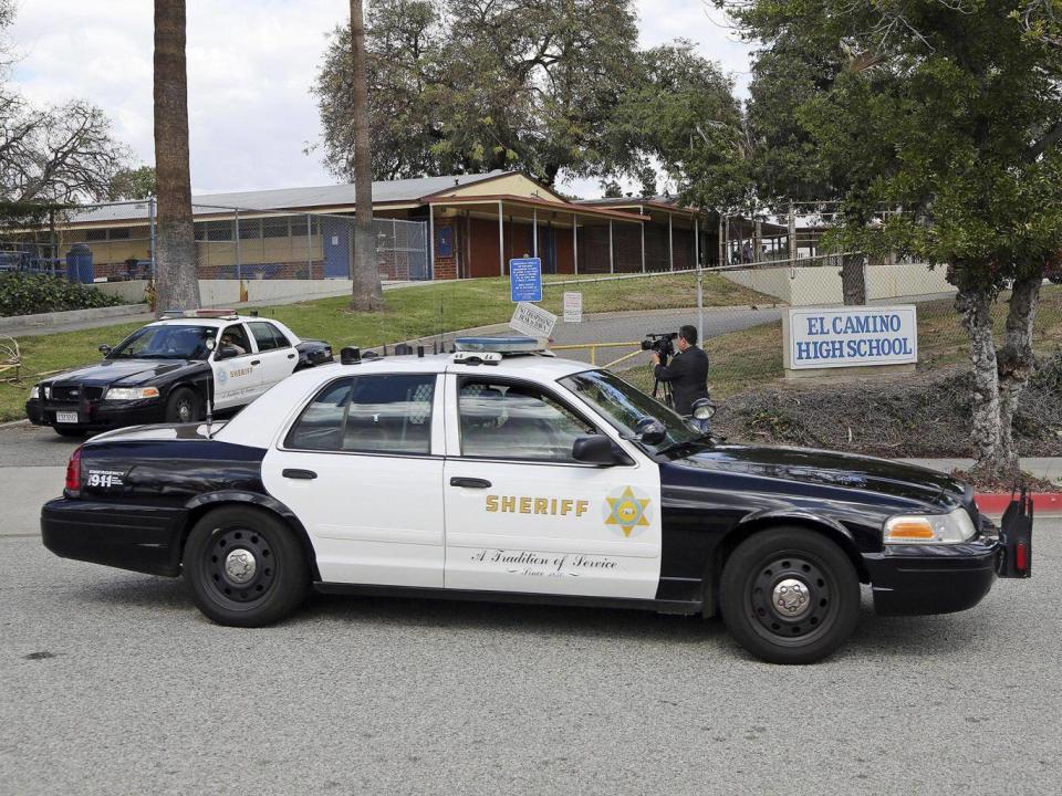 Los Angeles County Sheriff’s patrol cars leave El Camino High School in Whittier, California (AP Photo/Reed Saxon)