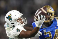 Coastal Carolina wide receiver Sam Pinckney, left, can't hold on to a pass while under pressure from UCLA defensive back Jaylin Davies during the first half of an NCAA college football game Saturday, Sept. 2, 2023, in Pasadena, Calif. (AP Photo/Mark J. Terrill)