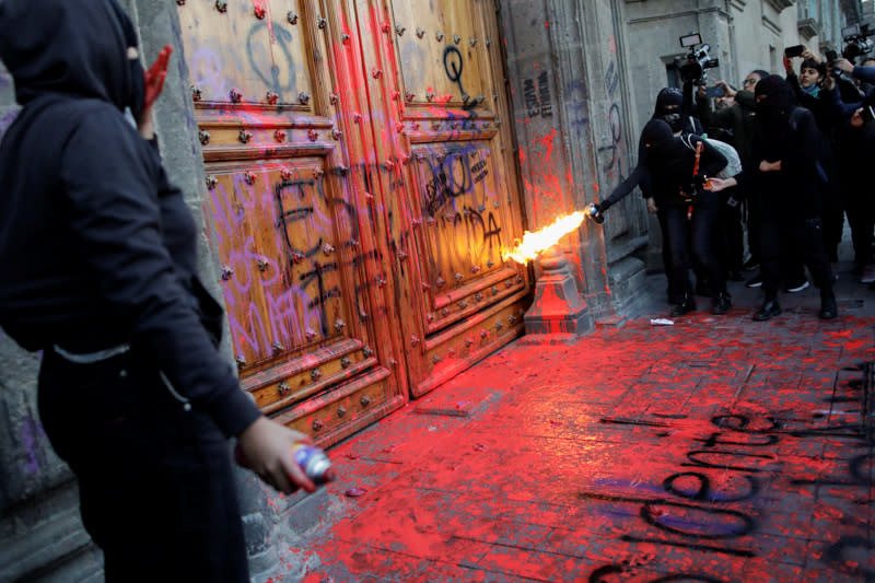 People take part in a protest against gender-based violence in downtown of Mexico City