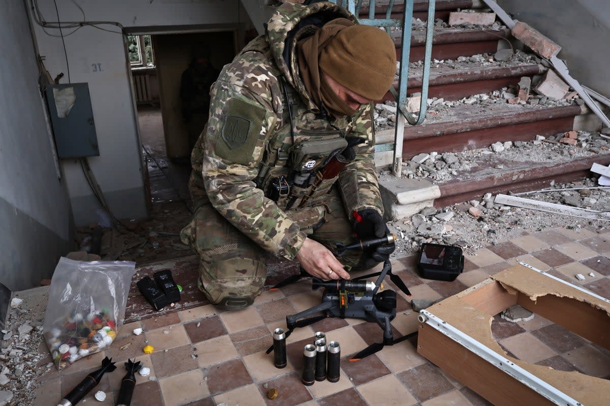 A Ukrainian soldier equips a drone with grenades in the area of the heaviest battles with the Russian invaders in Bakhmut, Donetsk (Copyright 2023 The Associated Press. All rights reserved)