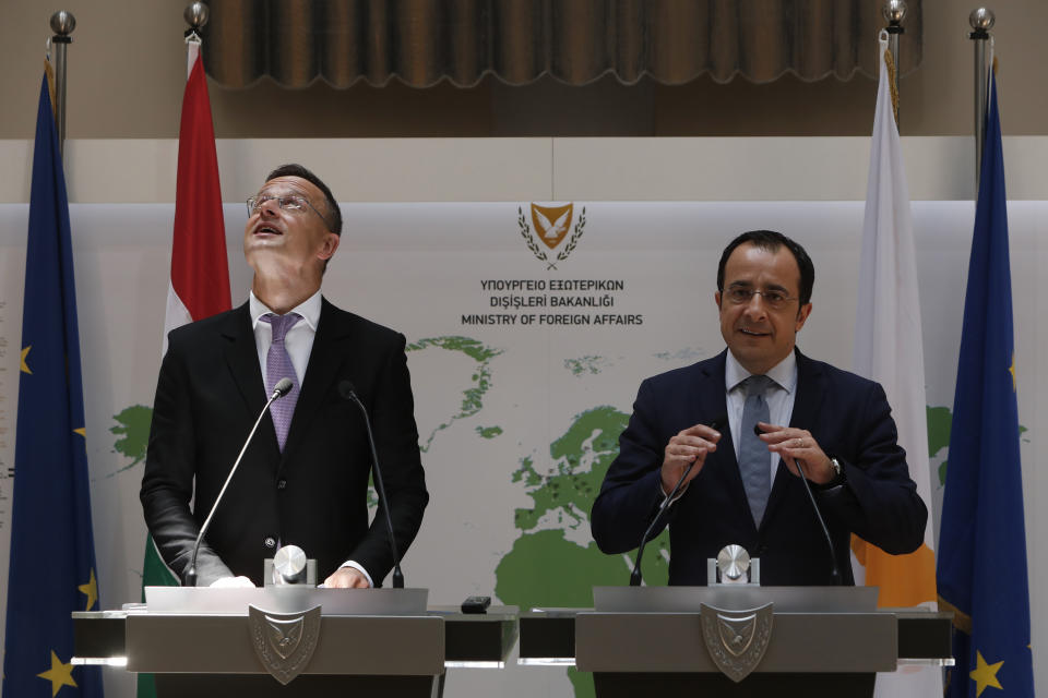 Hungarian Minister of Foreign Affairs and Trade Peter Szijjarto, left, and Cyprus' Foreign Minister Nikos Christodoulides speak during a news conference at the Cypriot foreign ministry on Friday, June 26, 2020. Szijjarto is in Cyprus for one-day visit. (AP Photo/Petros Karadjias)