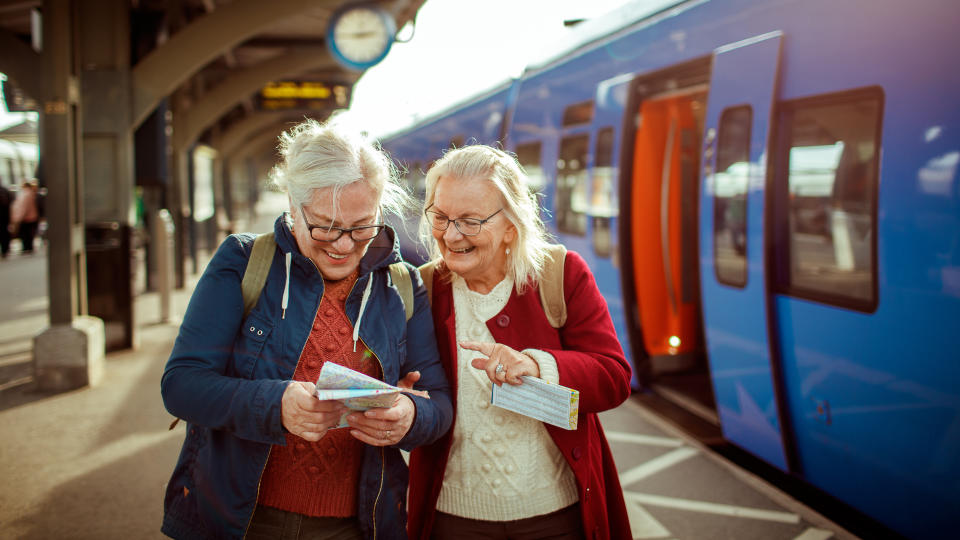 Close up of two seniors at a trainstation.