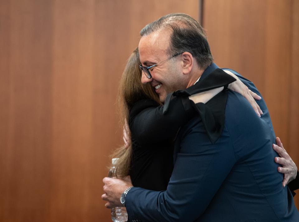 R.J. Nemer, dean of the College of Business and the new University of Akron president, hugs board of trustees member Christine Amer Mayer following the announcement of his new position on Wednesday.