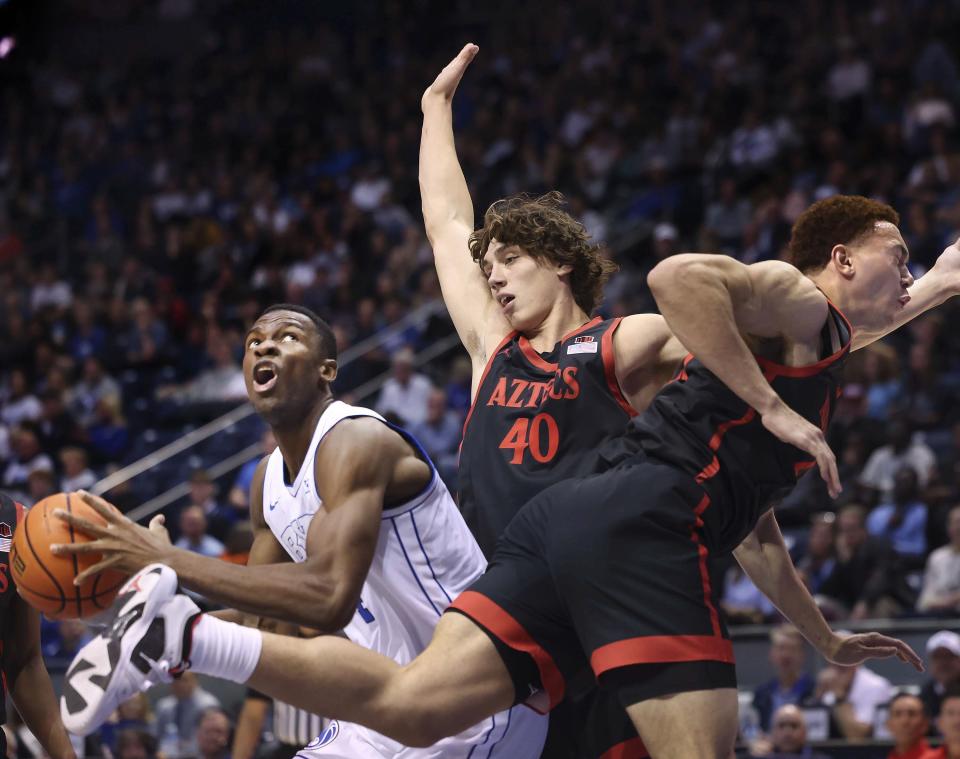 Brigham Young Cougars forward Atiki Ally Atiki (4) looks to shoot as San Diego State Aztecs forward Miles Heide (40) and forward Elijah Saunders (25) try to block him at BYU’s Marriott Center in Provo on Friday, Nov. 10, 2023. | Laura Seitz, Deseret News