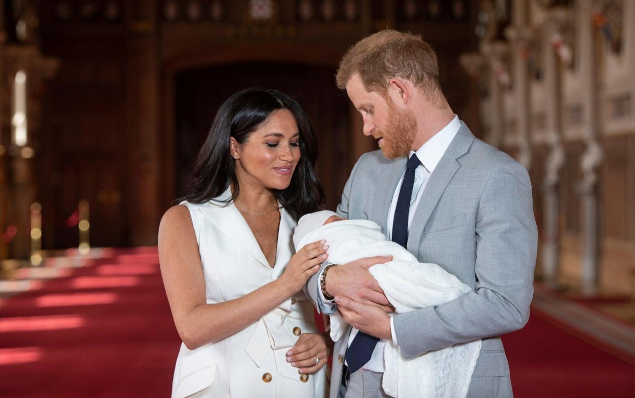 Prince Harry and Meghan, Duchess of Sussex, pose with their newborn son Archie - Dominic Lipinski/AP