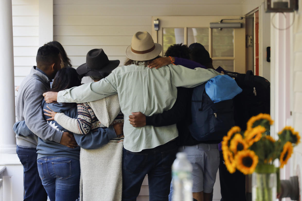 Martha's Vineyard, MA - September 16: Volunteers gather in a circle before helping Venezuelan migrants board busses outside of St. Andrew's Parish House. Two planes of migrants from Venezuela arrived suddenly two days prior causing the local community to mobilize and create a makeshift shelter at the church. (Photo by Carlin Stiehl for The Boston Globe via Getty Images)