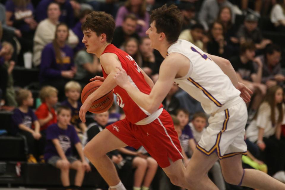 DCG's Jaden Jones drives past a Waukee player during a Class 4A high school boys basketball substate final on Tuesday, Feb. 28, 2023, at Waukee Northwest High School. Waukee won, 49-38.