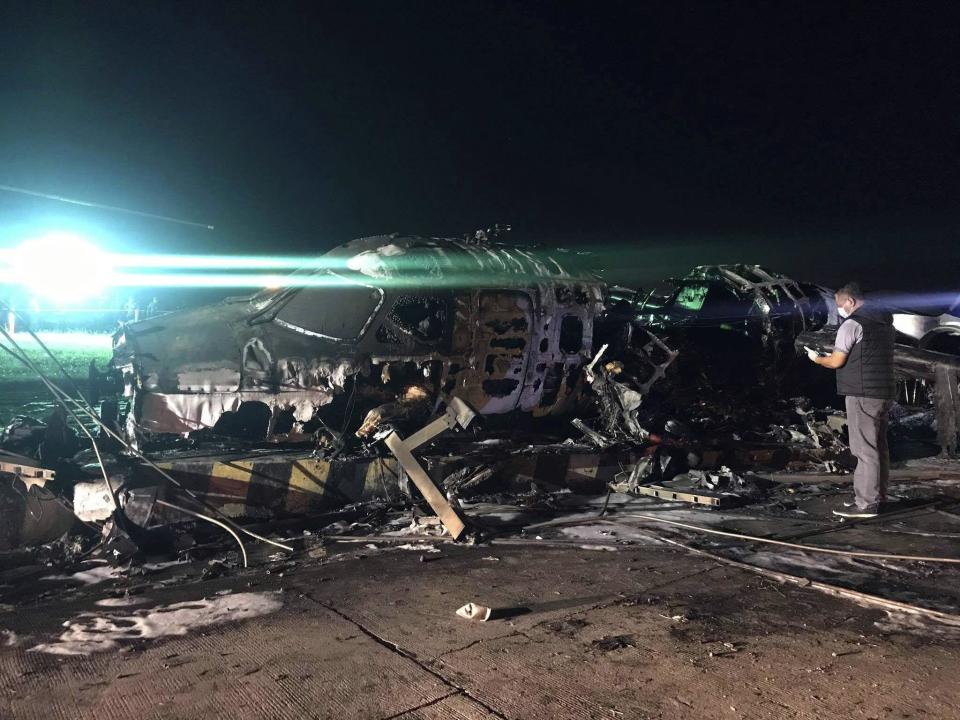 A man shoots video of the wreckage of a Lion Air, West Wind 24 aircraft (AP)