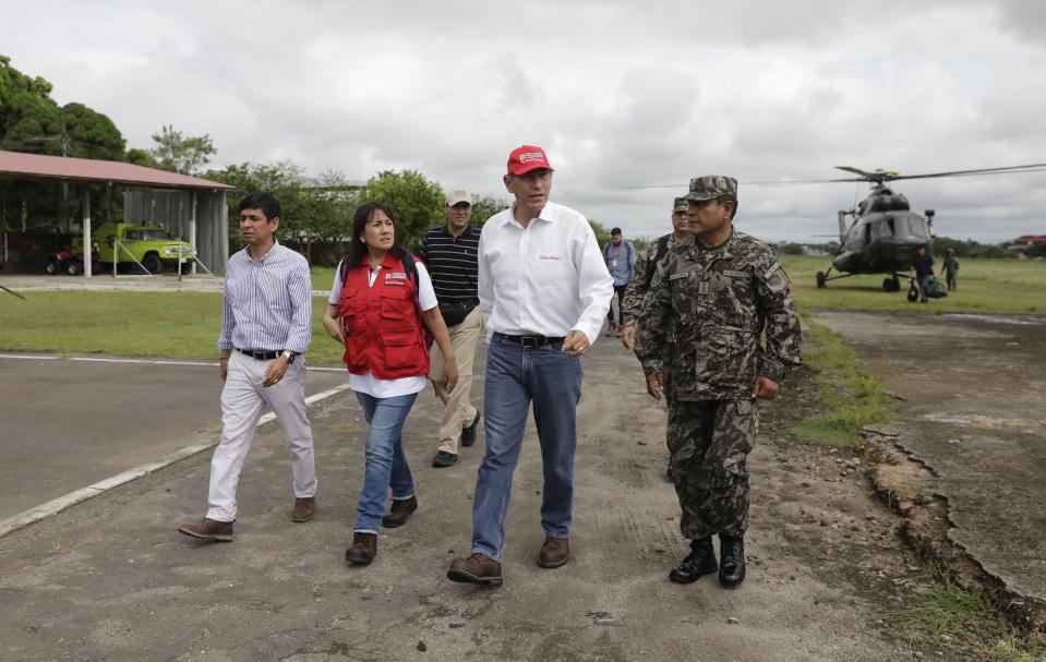 Peru's President Martin Vizcarra, second from right, arrives to the airport after checking earthquake-related damage by air as he arrives to Yurimaguas, Peru, Sunday, May 26, 2019. A powerful earthquake struck the Amazon jungle in north-central Peru early Sunday, collapsing buildings and knocking out power to some areas. (Guadalupe Pardo/Pool Photo via AP)