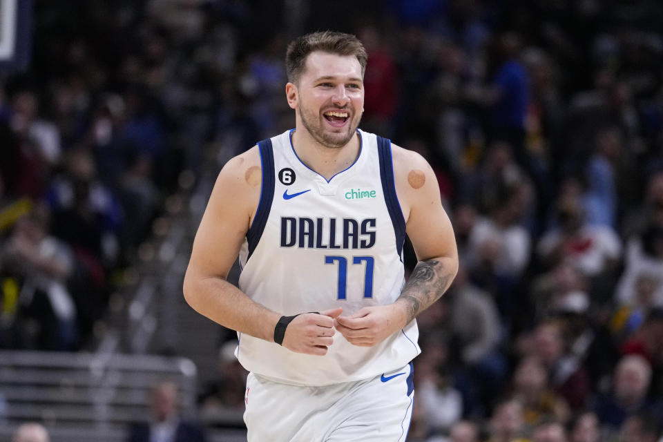 Dallas Mavericks guard Luka Doncic (77) smiles after a basket against the Indiana Pacers during the second half of an NBA basketball game in Indianapolis, Monday, March 27, 2023. The Mavericks defeated the Pacers 127-104. (AP Photo/Michael Conroy)