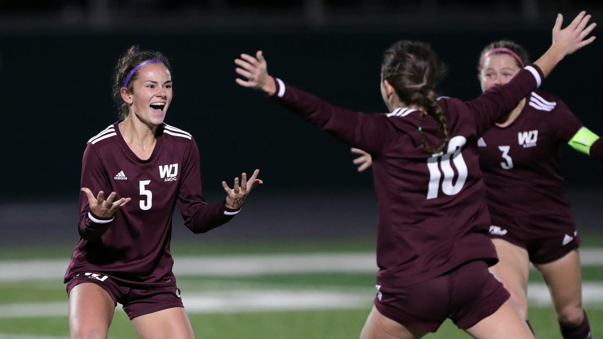 Walsh Jesuit's Hannah Pachan, facing, celebrates her game winning goal that lifted the Warriors to a 2-1 win over Strongsville and put the Warriors into the Division I state final.
