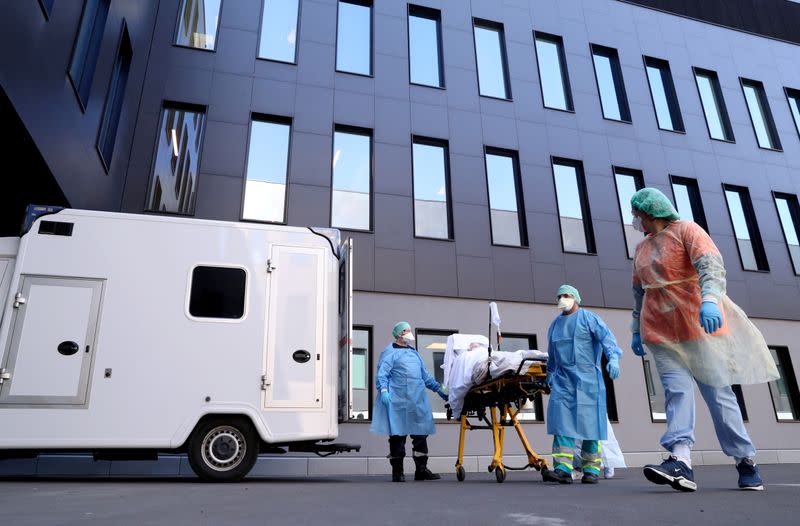 FILE PHOTO: Medical staff arrive with a patient affected by COVID-19 at CHC Montlegia hospital in Liege