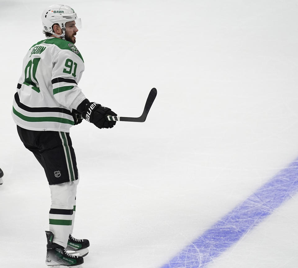 Dallas Stars center Tyler Seguin watches his empty-net goal against the Colorado Avalanche during the third period of Game 3 of an NHL hockey Stanley Cup playoff series Saturday, May 11, 2024, in Denver. (AP Photo/David Zalubowski)