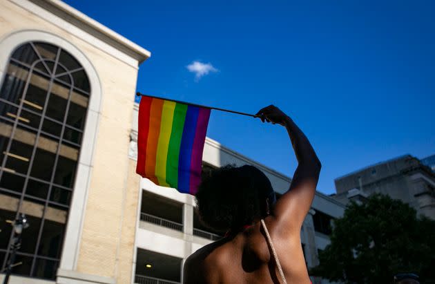 A person waves a rainbow flag during celebrations for Pride Month on June 25 in Raleigh, North Carolina. A written opinion by one justice in the Supreme Court's decision to bury abortion rights has ignited fears that other progressive gains, including same-sex marriage and contraception, could also be overturned. (Photo: ALLISON JOYCE via Getty Images)