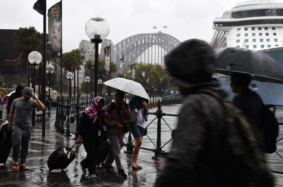 People shelter from the rain