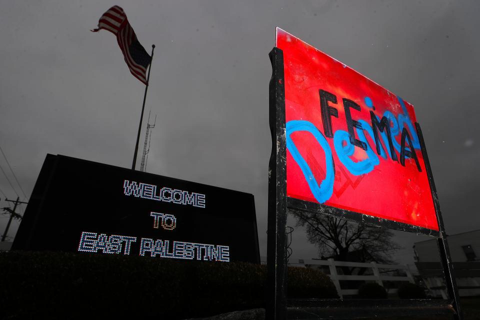 A sign that says "FEMA Denied" was posted in front of a video board welcoming visitors to East Palestine, Ohio, on Friday. The Federal Emergency Management Agency initially said Ohio is not eligible for assistance, according to the governor's office.