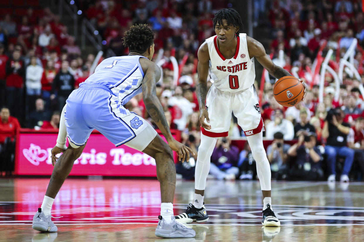 NC State guard Terquavion Smith dribbles against North Carolina forward Leaky Black during the first half of the game at PNC Arena in Raleigh, North Carolina, on Feb. 19, 2023. (Jaylynn Nash/USA TODAY Sports)