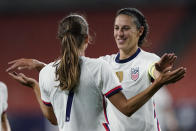 U.S. forward Carli Lloyd, right, congratulates Tobin Heath after Heath scored during the second half of the team's international friendly soccer match against Paraguay, Thursday, Sept. 16, 2021, in Cleveland. The United State won 9-0. (AP Photo/Tony Dejak)