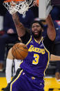 Los Angeles Lakers forward Anthony Davis dunks during the first half of the team's NBA basketball game against the Memphis Grizzlies on Friday, Feb. 12, 2021, in Los Angeles. (AP Photo/Mark J. Terrill)