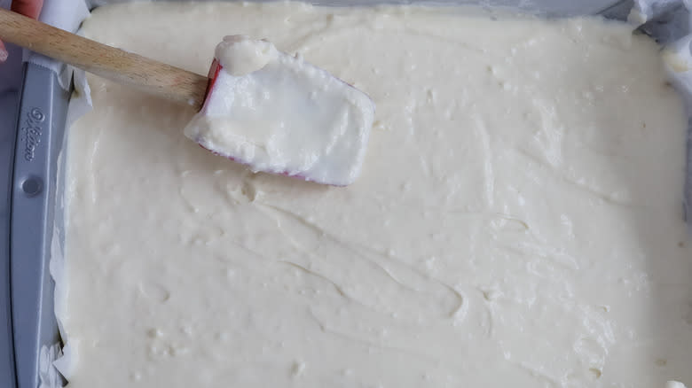 white batter in pan with rubber spatula