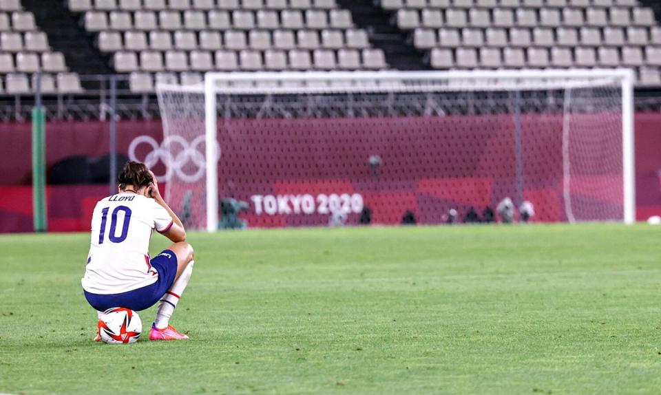 U.S. forward Carli Lloyd sits alone on the field after the team's loss to Canada in the Tokyo Olympics last August.