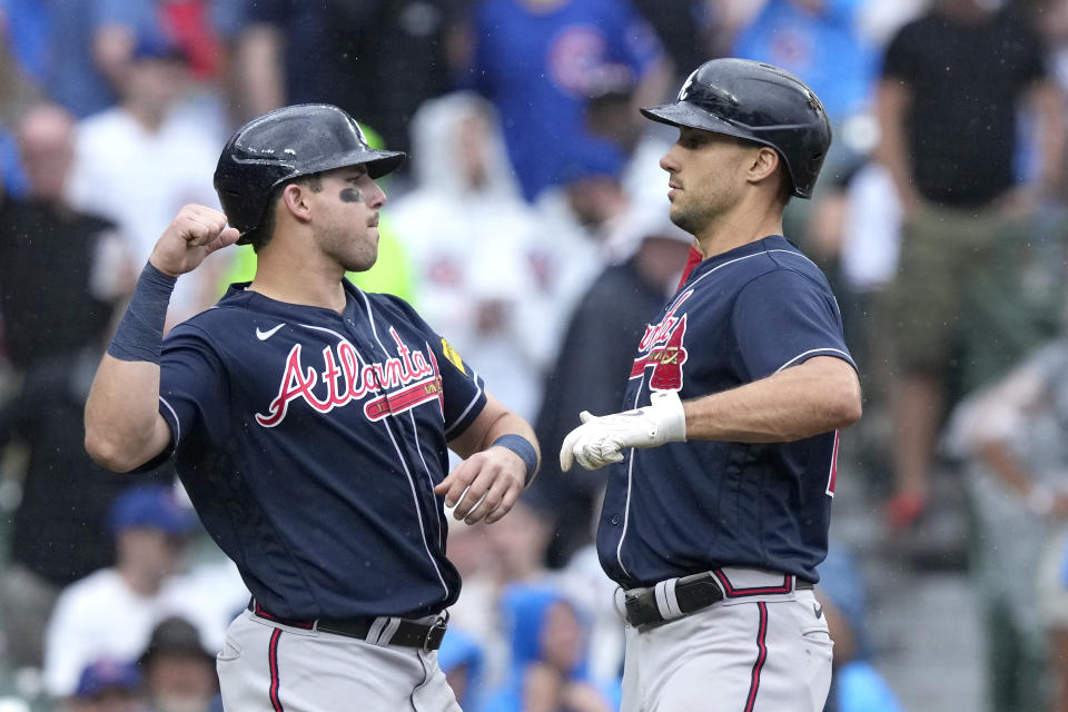 Atlanta Braves' Austin Riley, left, greets Matt Olson at home after they scored on Olson's two-run home run off Chicago Cubs relief pitcher Adbert Alzolay during the ninth inning of a baseball game Saturday, Aug. 5, 2023, in Chicago. (AP Photo/Charles Rex Arbogast)