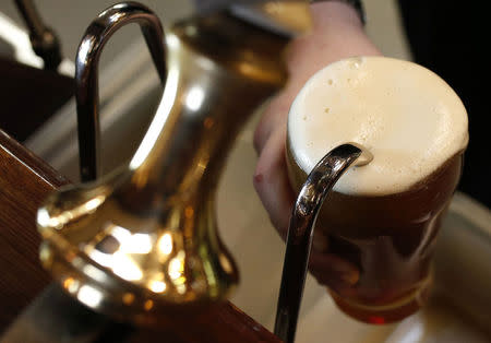 A barman pulls a pint of beer in a pub in Liverpool northern England November 19 , 2014. REUTERS/Phil Noble