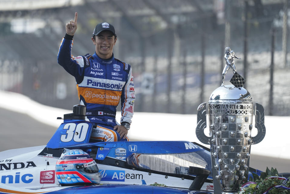 Takuma Sato, of Japan, winner of the 2020 Indianapolis 500 auto race, poses during the traditional winners photo session at the Indianapolis Motor Speedway, Monday, Aug. 24, 2020, in Indianapolis. (AP Photo/Darron Cummings)