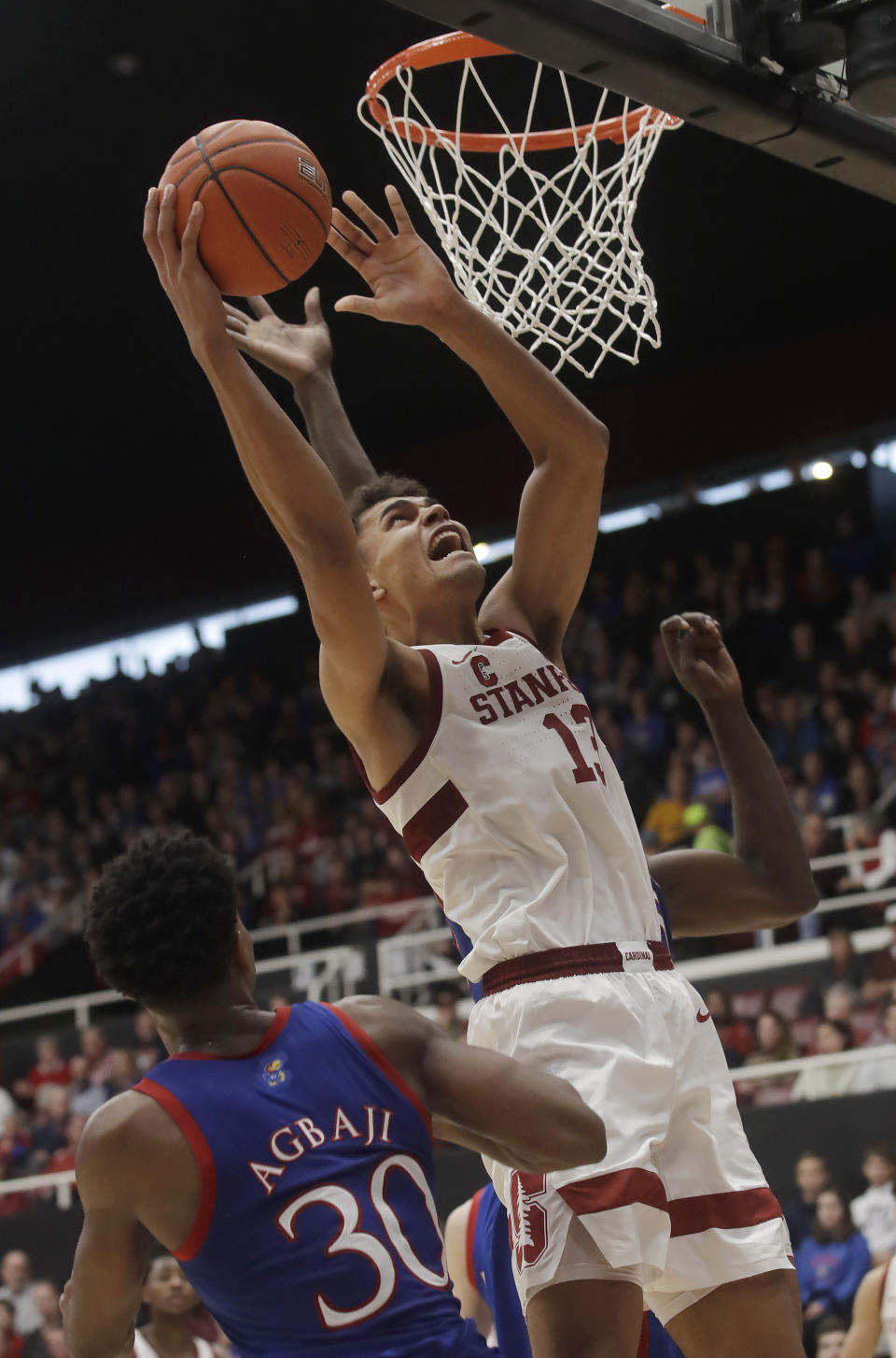 Stanford forward Oscar da Silva (13) shoots over Kansas guard Ochai Agbaji (30) during the first half of an NCAA college basketball game in Stanford, Calif., Sunday, Dec. 29, 2019. (AP Photo/Jeff Chiu)