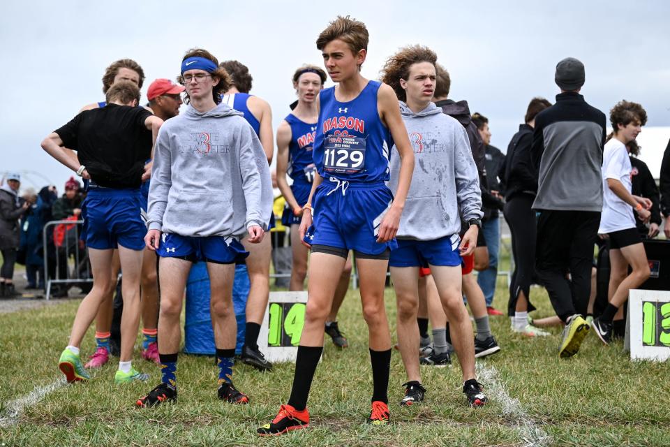 Mason's Alex Doneth, center, and the rest of the Bulldogs prepare for the Division 2 boys state cross country final on Saturday, Nov. 5, 2022, at Michigan International Speedway in Brooklyn.