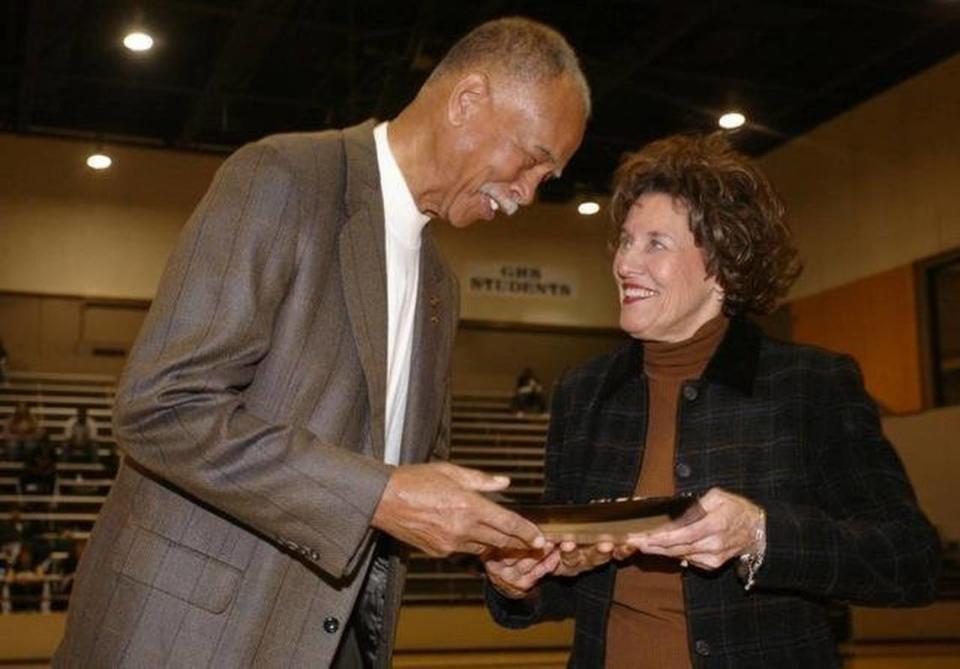 Retired Dunbar coach Robert Hughes (the boys all-time winningest coach) presents Granbury girls coach Leta Andrews, the new all time winningest girls basketball coach in the country, with a platter honoring her achievement during a celebration at the halftime of a basketball game at Granbury High School gym Dec. 10, 2005.