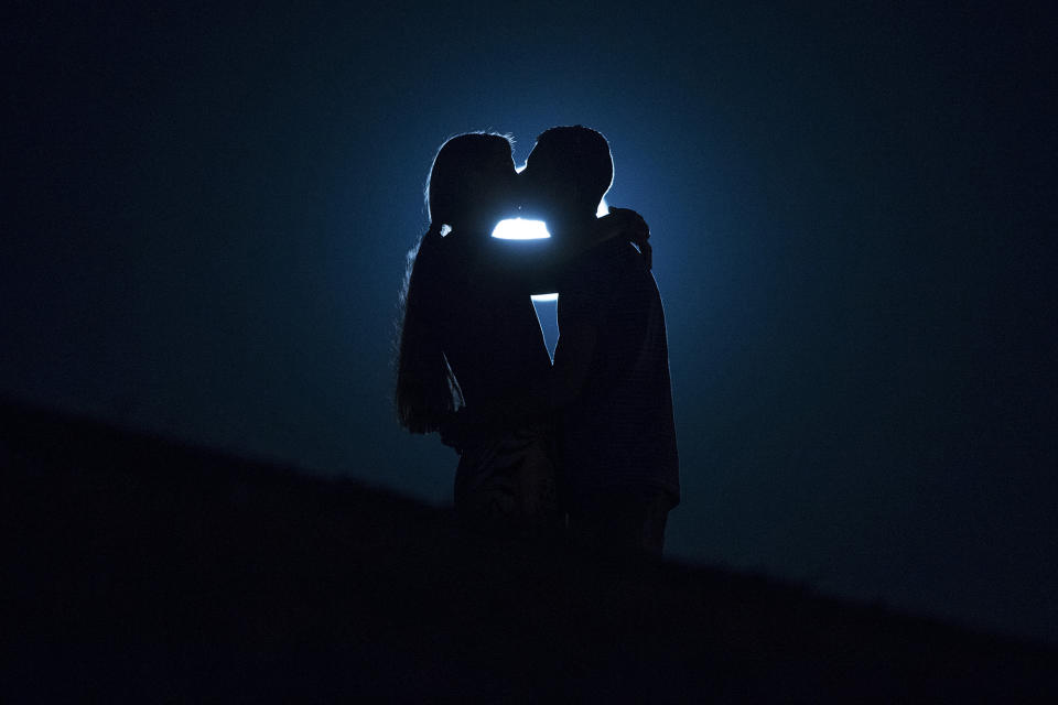 <p>A perigee moon, also known as a supermoon, rises in the sky as a couple kiss in Madrid, Sept. 9, 2014. (AP Photo/Andres Kudacki) </p>
