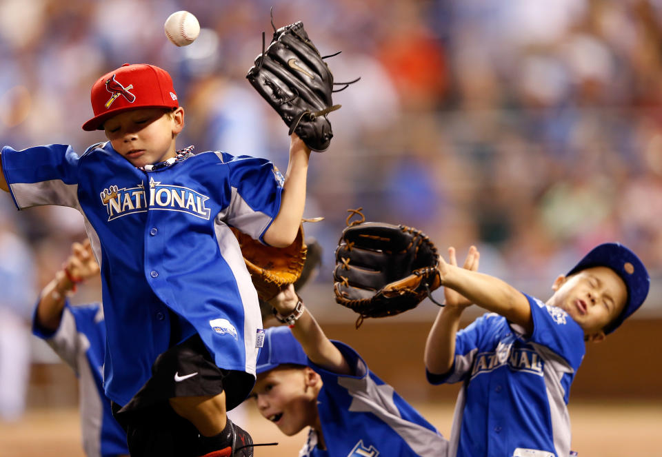 Player's kids go after the ball during the State Farm Home Run Derby at Kauffman Stadium on July 9, 2012 in Kansas City, Missouri. (Photo by Jamie Squire/Getty Images)