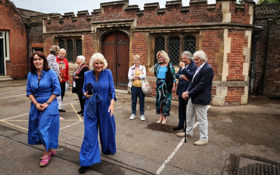 The Queen arrived at the palace in a cobalt blue Anna Valentine jumpsuit - Adrian Dennis