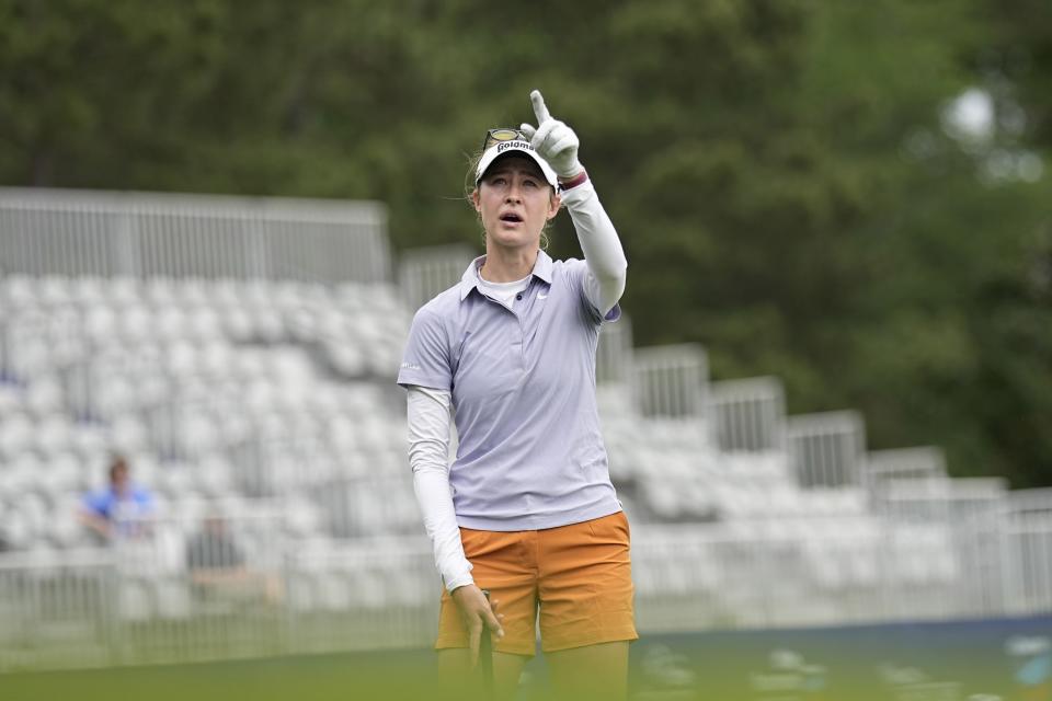 Nelly Korda points up while chipping on the 18th hole during a practice round for The Chevron Championship golf tournament Wednesday, April 19, 2023, in The Woodlands, Texas. (AP Photo/David J. Phillip)