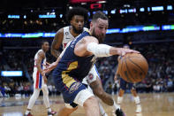 New Orleans Pelicans center Jonas Valanciunas (17) pulls in the ball near the baseline against Detroit Pistons forward Marvin Bagley III in the first half of an NBA basketball game in New Orleans, Wednesday, Dec. 7, 2022. (AP Photo/Gerald Herbert)