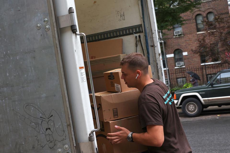 Dusan B., a mover with Rabbit Movers, places the belongings of a customer onto a moving truck on August 13 in New York City.