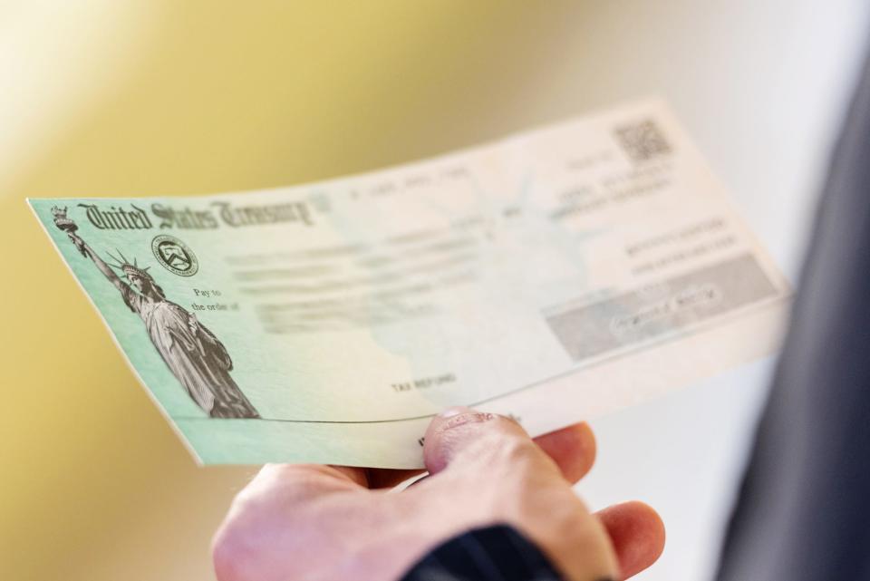 Men hands holding a US Government Treasury check