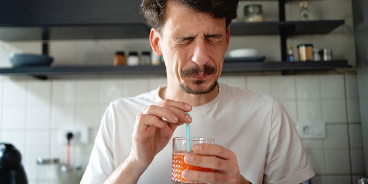 man making the face after he tasted the juice